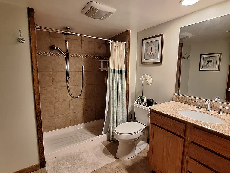 Basement has full bath with tiled shower and multiple shower heads