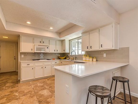 Kitchen has new quartz counter tops, subway tile back splash, and freshly painted cabinets!