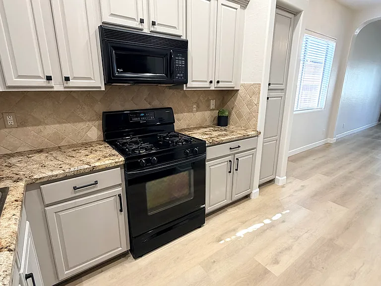 Granite countertop and tile backsplash