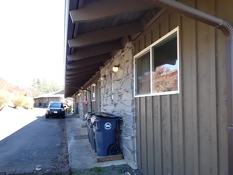 Unit 3 front looking down building with laundry room next door