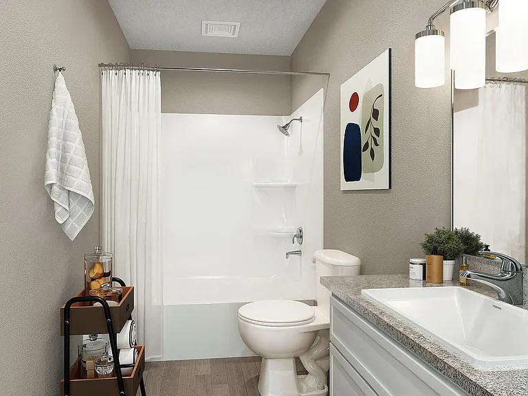 Bright bathroom with granite counters and bathtub