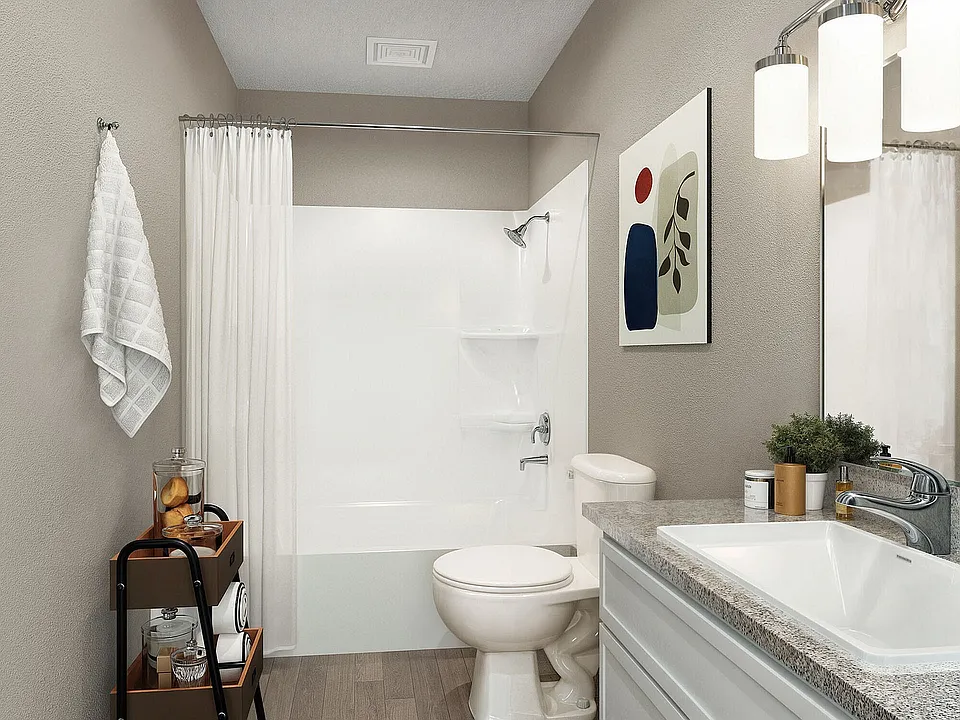 Bright bathroom with granite counters and bathtub