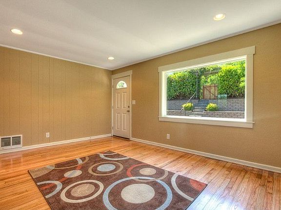 Well lit with lots of natural light through the living room picture window to private front yard. No