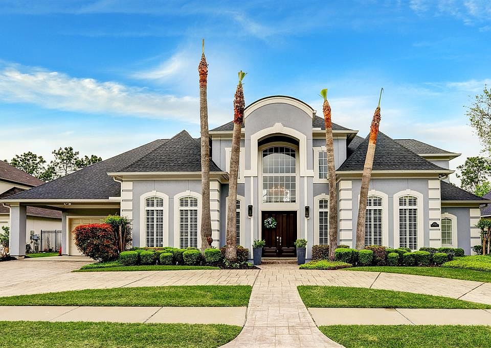 Gorgeous home in manned gated Master Planned community of Lakes on Eldridge with easy access to Houston's "Energy Corridor" on very special lake lot with pool. On either side of the double doors are gas lantern. Mature palm trees, in the front of the