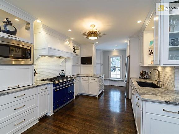 Bright chefs kitchen w/Lacanche gas range, marble countertops, wine fridge & large pantry