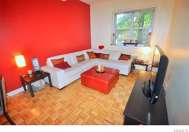 Large living room has 9'- 6" beamed ceilings, refinished parquet floors and is large enough for both a living area and dining area.