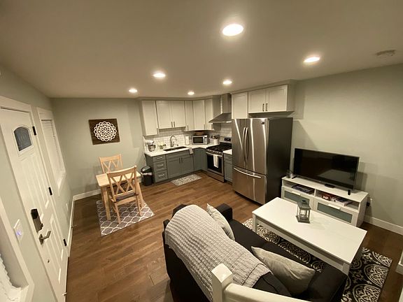 First floor: open concept living room, kitchen dining room with recessed lighting and two windows.