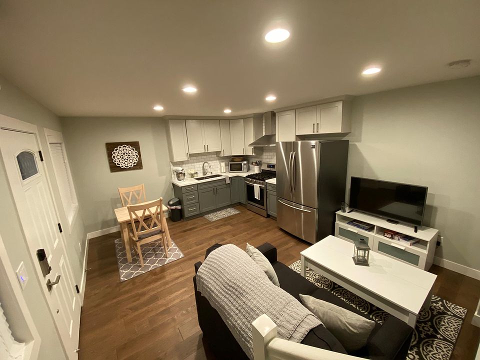 First floor: open concept living room, kitchen dining room with recessed lighting and two windows.