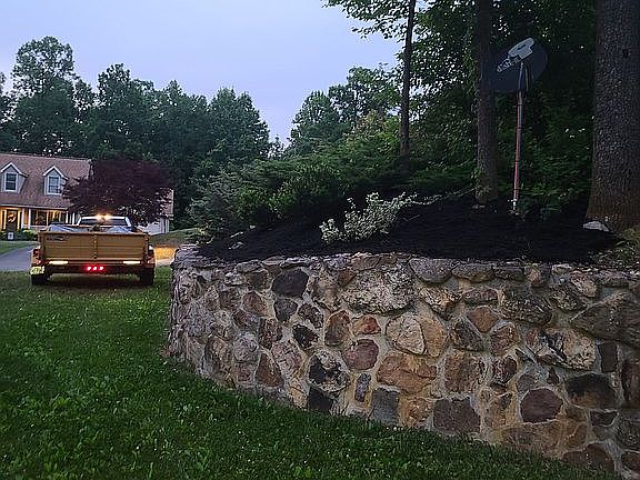 Rock wall on left side of home