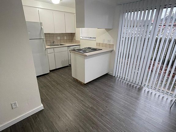 Dining room and kitchen, leads to back patio that is fenced