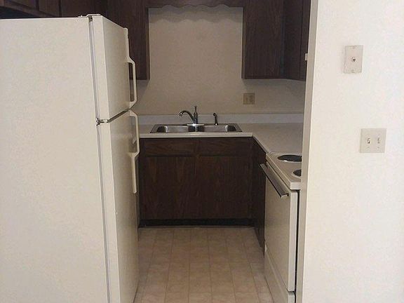 Galley kitchen. Includes stove, refrigerator, dishwasher and