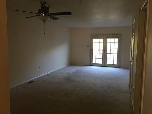 Large living and dining room with French doors to deck