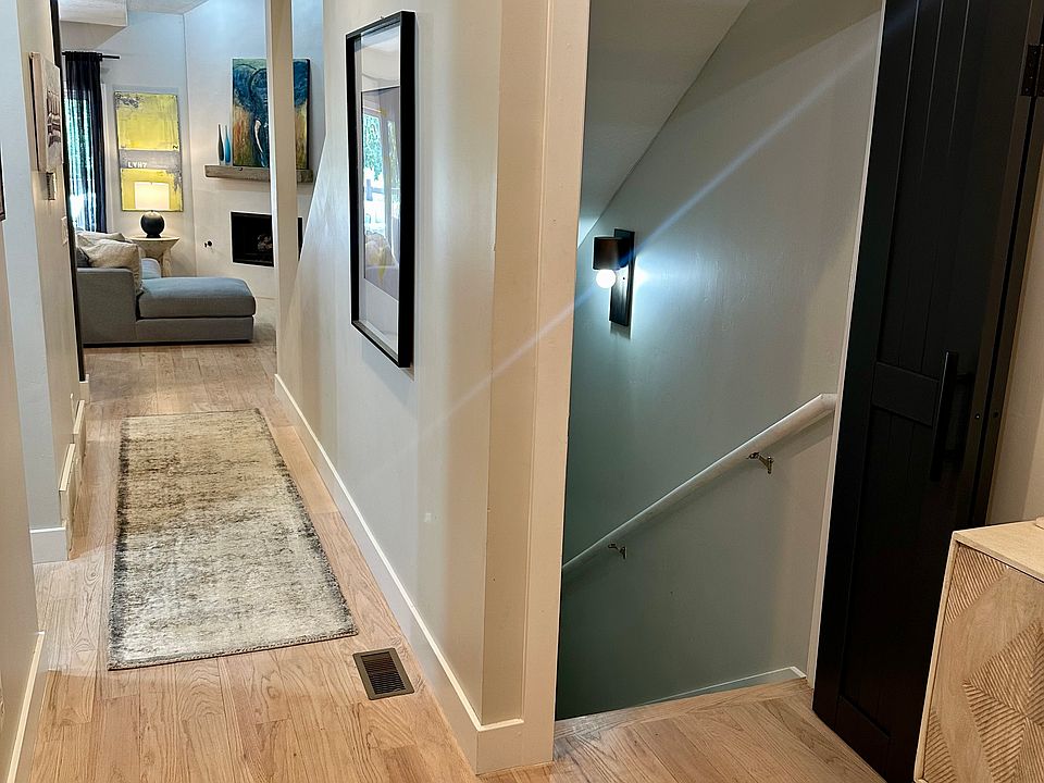 Entry with door open to bottom floor which is the 3rd bedroom or second living area/home office.