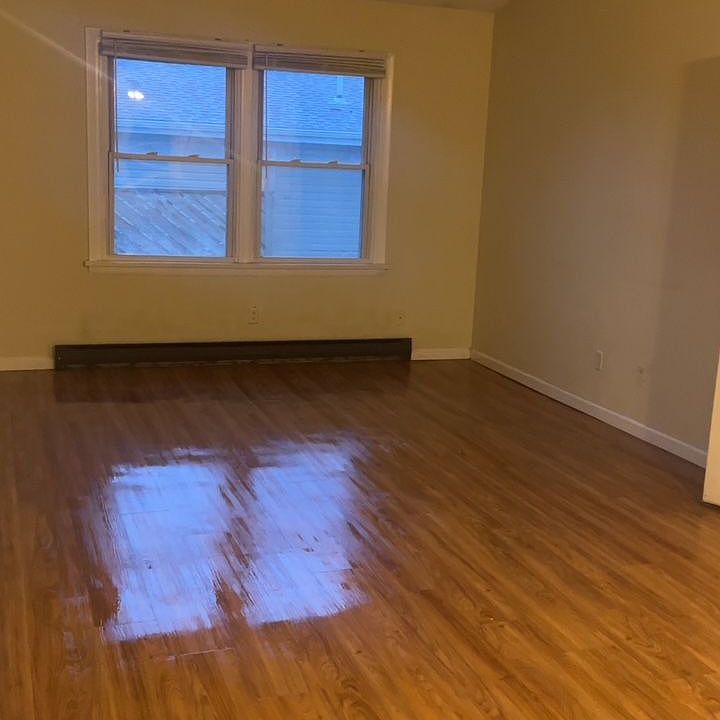 Large main living area features striking recently updated flooring.