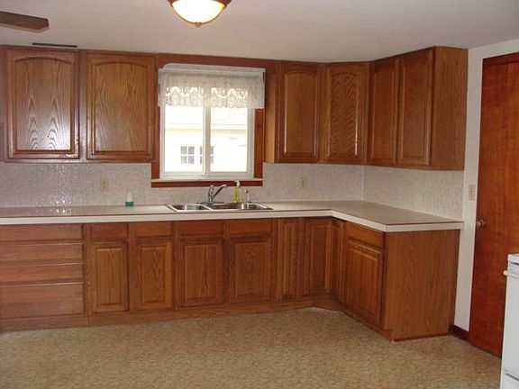 The kitchen is extra large with updated kitchen including the cabinets.The refrigerator is to the left.