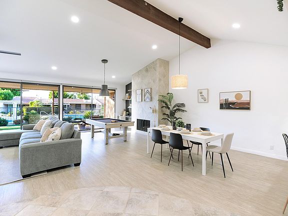 California Desert inspired decor! Open concept living area featuring dining area, a pool table and plush sofa.