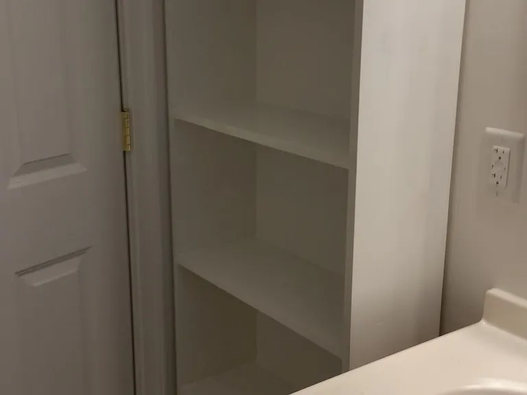 Shelving next to bathroom sink.