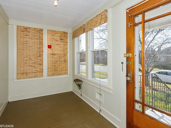 Then vintage front door opens to the enclosed front porch!