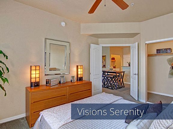 A bedroom with a ceiling fan and large closet