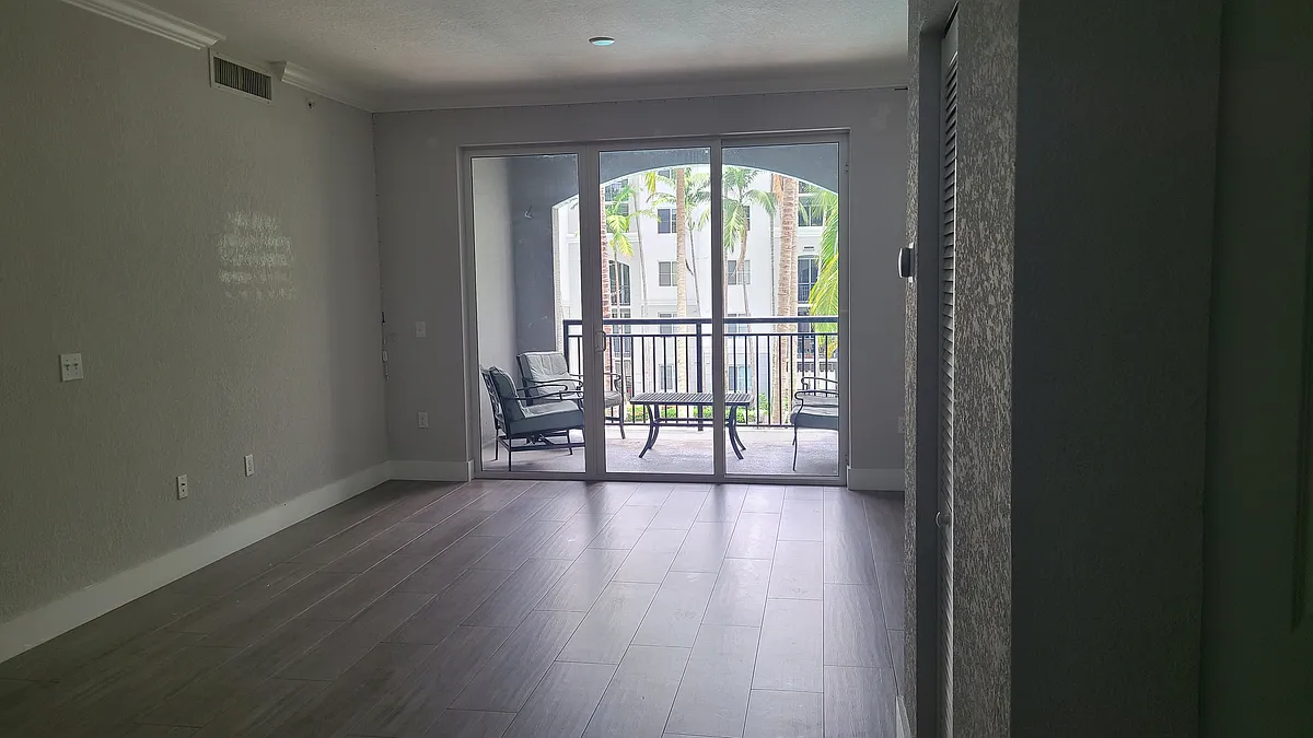 Living room & Dining room with view of covered Balcony - 1690 Renaissance Commons Blvd #1323