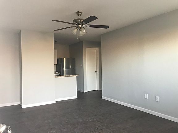 Open concept Living & Kitchen; ceiling fan and large picture
