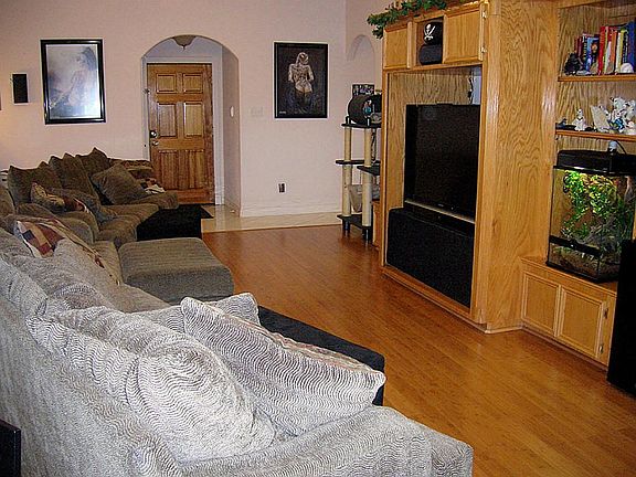 Spacious family room has bamboo wood & tile floor, custom media center,corner FP,high ceiling w/ crown molding