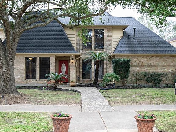 The home has excellent curb appeal with a brick elevation and gorgeous trees!