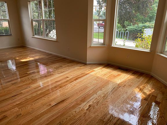 Freshly refinished red oak hardwood floors in living and dining rooms