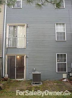 Rear of the unit : Enclosed flower beds; brick patio; heat pump unit only 3 yrs. old.