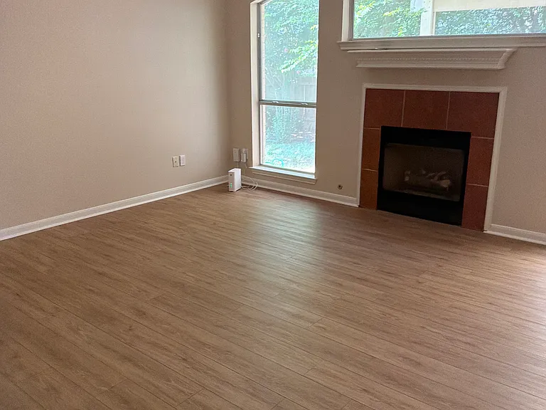 Back into Main Floor Living Room showing windows and fireplace. Very cozy in winter and comfortable in summer thanks to the new air conditioner.