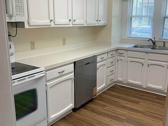 Kitchen with new flooring, new dishwasher, new fridge, and new microwave.
