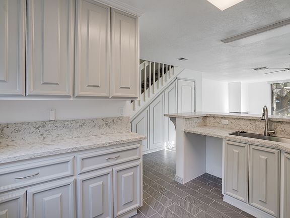 Custom Countertops, Lazy Sussane cabinet for easy access.