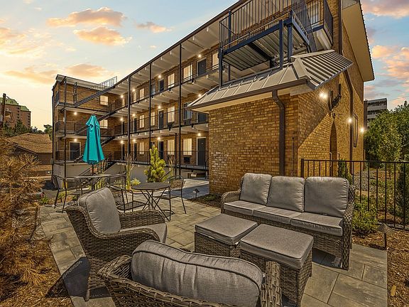 Experience serene evenings in this beautifully designed apartment complex with inviting outdoor spaces.