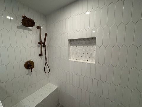 Custom tile work, including shower bench and oversized shampoo storage area