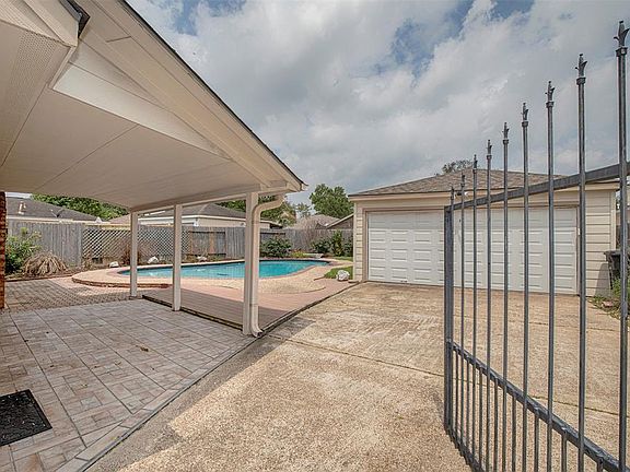 The two-car garage sits behind the large gate.