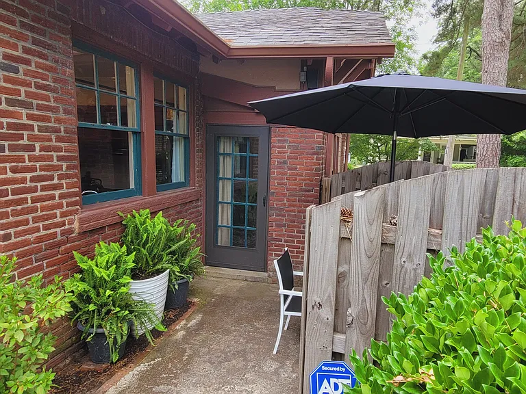 Private fenced patio area off of door to dining room overlooked by windows from the kitchen