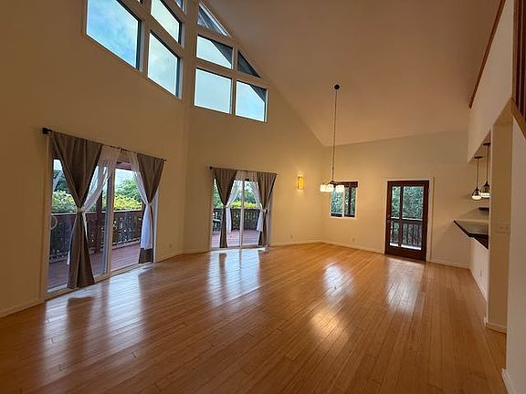 Open concept living room and dining room with cathedral ceilings