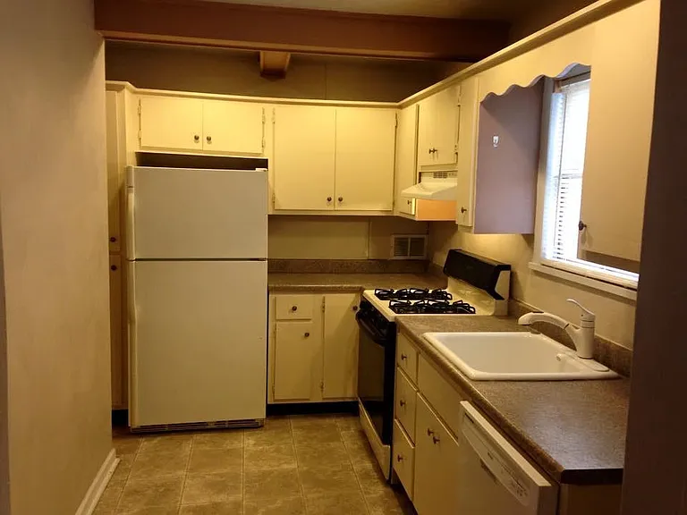 Kitchen with fridge, gas stove and dishwasher included. Currently remodeling the kitchen with new cabinets and flooring for a different layout to provide more counter space.