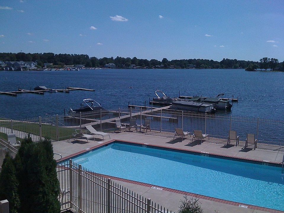 View from Living Room shows the large, heated pool and Pine Lake beyond.