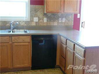 Nice stone back splash around kitchen cabinets.