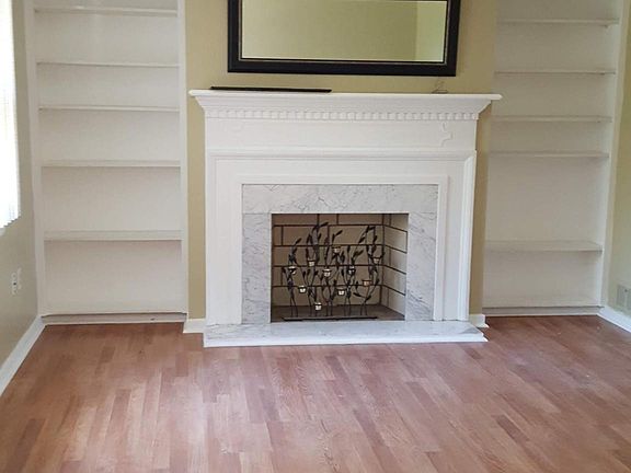 Living Room | Viewed from Entrance Hallway | Faux Fireplace | Built-in bookshelves | Laminate flooring