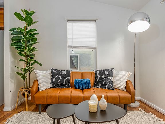 Caramel leather loveseat sits at the heart of the 2nd house living room
