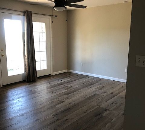 Newer flooring walks out to deck with a spacious storage closet