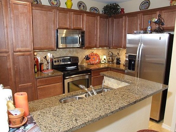 Upgrades include granite countertops, backsplash, and stainless steel