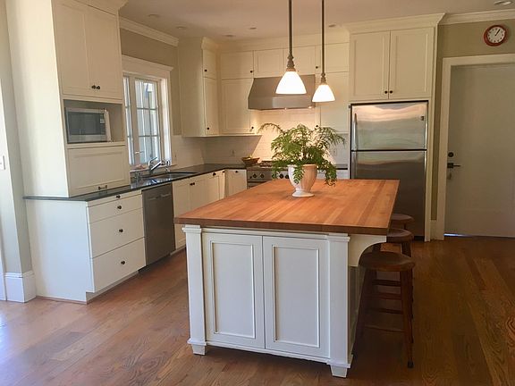 Door off kitchen leads to separate bedroom or office suite wing, with full bath and private outside entry