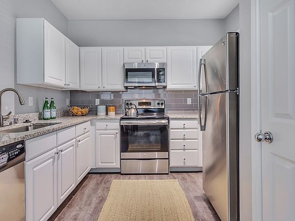 Chef-inspired kitchens feature stainless steel appliances and ample counter space for food prep.