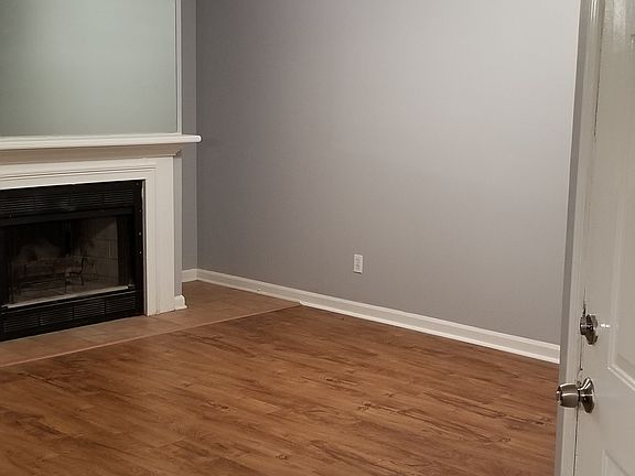 Front door entrance and living room with fireplace.