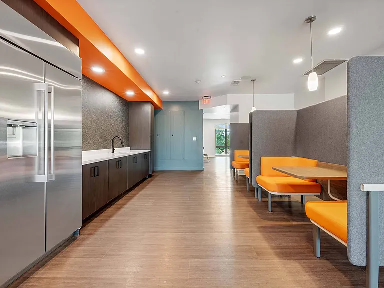 Gather in the community kitchen with cozy eating booths, perfect for shared meals, conversations, and connection.