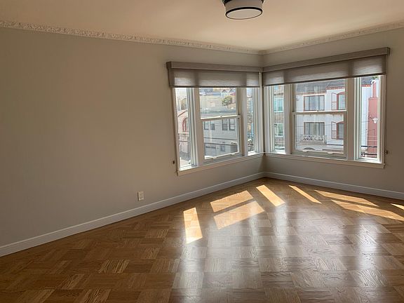 Living room with window screens and shades