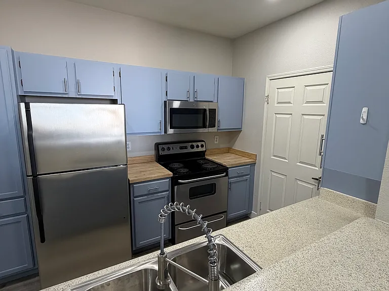 Living area looking into kitchen. New ceiling lights, new sink with new garbage disposal